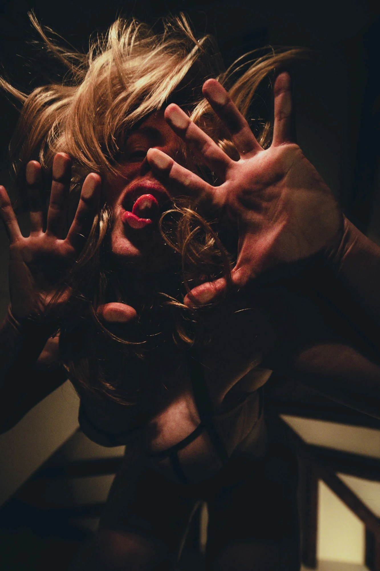 Expressive energetic creator shoot through transparent glass with warm lighting