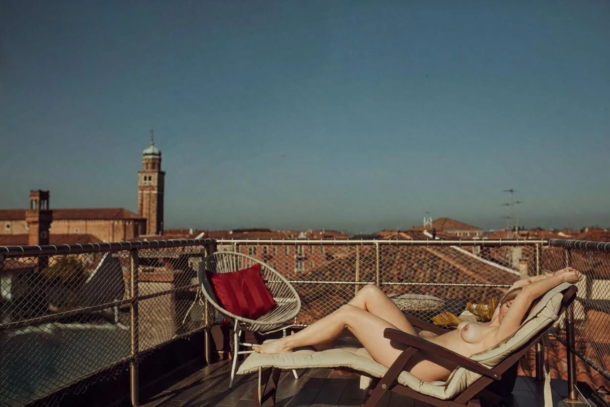 Natural light creator session on an Italian rooftop terrace overlooking historic city roofs