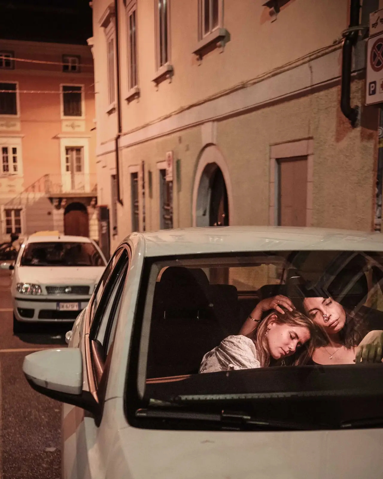 Two friends sharing a quiet moment on an Italian street